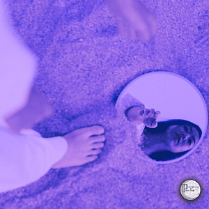 wp-17178794776569071018098832780597 a person looking into a mirror in the sand